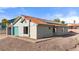 Charming single-story home featuring a teal garage door, tile roof, and low-maintenance desert landscaping at 1775 Esteban Ave, Laughlin, NV 89029