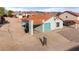 Charming single-story home featuring a teal garage door, tile roof, and low-maintenance desert landscaping at 1775 Esteban Ave, Laughlin, NV 89029