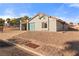 Charming single-story home featuring a teal garage door, tile roof, and low-maintenance desert landscaping at 1775 Esteban Ave, Laughlin, NV 89029