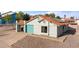 Charming single-story home featuring a teal garage door, tile roof, and low-maintenance desert landscaping at 1775 Esteban Ave, Laughlin, NV 89029