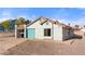 Charming single-story home featuring a teal garage door, tile roof, and low-maintenance desert landscaping at 1775 Esteban Ave, Laughlin, NV 89029