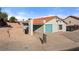 Exterior view of the home featuring a turquoise garage door and desert landscaping at 1775 Esteban Ave, Laughlin, NV 89029