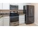 Well-lit kitchen featuring stainless steel appliances, ample white cabinetry, and granite countertops at 1775 Esteban Ave, Laughlin, NV 89029