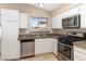Bright kitchen featuring stainless appliances, white cabinets, granite counters, and a window over the sink at 1775 Esteban Ave, Laughlin, NV 89029