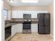 Fully equipped kitchen featuring stainless steel appliances, ample white cabinetry, and granite countertops at 1775 Esteban Ave, Laughlin, NV 89029
