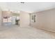 Spacious living room with neutral carpet, lots of light, and views of the backyard at 1775 Esteban Ave, Laughlin, NV 89029