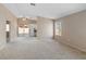 Bright and airy living room with a view into the kitchen and sliding door to the backyard at 1775 Esteban Ave, Laughlin, NV 89029