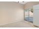 Spacious main bedroom featuring neutral carpeting, a ceiling fan, and backyard access via sliding glass doors at 1775 Esteban Ave, Laughlin, NV 89029