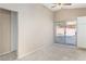 Spacious main bedroom featuring neutral carpeting, a ceiling fan, and backyard access via sliding glass doors at 1775 Esteban Ave, Laughlin, NV 89029