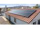 Aerial view of home featuring efficient solar panels on a red tile roof with mountain views at 1775 Esteban Ave, Laughlin, NV 89029