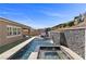 Backyard pool and spa with waterfall feature and lush landscaping, perfect for entertaining at 18 Via Tiberina, Henderson, NV 89011