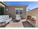 Cozy backyard featuring a modern fireplace and comfortable patio seating at 18 Via Tiberina, Henderson, NV 89011