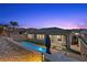A serene backyard featuring a sparkling pool, patio, and lush landscaping at 18 Via Tiberina, Henderson, NV 89011