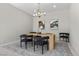 Bright dining area with modern table, sleek chairs, elegant chandelier, and tasteful artwork on the walls at 18 Via Tiberina, Henderson, NV 89011