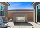 A modern outdoor fireplace creates a warm and inviting ambiance in the backyard patio at 18 Via Tiberina, Henderson, NV 89011
