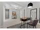 Open-concept entry with a stylish console table, an adjacent home office and contemporary light fixtures at 18 Via Tiberina, Henderson, NV 89011