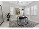 Bright home office features neutral walls, plantation shutters, modern desk, rug and stylish decor at 18 Via Tiberina, Henderson, NV 89011