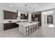 Spacious kitchen features an oversized island, stainless steel appliances, and dark wood cabinets at 18 Via Tiberina, Henderson, NV 89011