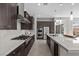 Well-equipped kitchen with stainless steel appliances, gas cooktop, and a large center island at 18 Via Tiberina, Henderson, NV 89011