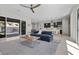 Spacious living room with a modern sofa, large windows, and open-concept design at 18 Via Tiberina, Henderson, NV 89011