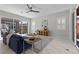 Bright living room with large windows, modern furniture, and access to the backyard patio at 18 Via Tiberina, Henderson, NV 89011