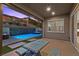 Inviting covered patio with outdoor seating, pool and landscaped backyard under a lovely twilight sky at 18 Via Tiberina, Henderson, NV 89011