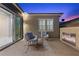 Cozy patio features a modern fireplace, comfortable seating, and sliding glass doors to the interior at 18 Via Tiberina, Henderson, NV 89011