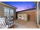 This outdoor patio includes lounge chairs, a modern fireplace, and block wall for privacy at 18 Via Tiberina, Henderson, NV 89011