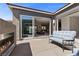 Modern outdoor patio featuring a linear fireplace and sliding glass doors to the home's interior at 18 Via Tiberina, Henderson, NV 89011