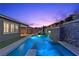 Stunning backyard pool with integrated spa and stone waterfall feature, perfect for relaxation and entertaining at 18 Via Tiberina, Henderson, NV 89011