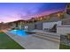 Gorgeous backyard pool with integrated spa, multiple water features and lounge chairs on the pool deck at 18 Via Tiberina, Henderson, NV 89011