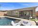 Inviting backyard oasis with a sparkling pool, fire pit, and seamless indoor-outdoor living at 18 Via Tiberina, Henderson, NV 89011