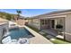 Stunning backyard with a sleek pool, lush turf, and an inviting outdoor living space at 18 Via Tiberina, Henderson, NV 89011