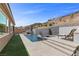 Backyard pool with a waterfall feature and lush landscaping, creating a relaxing oasis at 18 Via Tiberina, Henderson, NV 89011