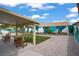 Inviting backyard featuring a covered patio, gravel, and a green turf area for outdoor activities at 1830 Ginger Blossom Ave, North Las Vegas, NV 89031