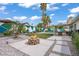 Inviting backyard featuring a cozy fire pit, modern landscaping, and covered patio area, perfect for outdoor relaxation at 1830 Ginger Blossom Ave, North Las Vegas, NV 89031