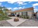 Landscaped backyard featuring a fire pit, patio, turf, gravel and privacy wall at 1830 Ginger Blossom Ave, North Las Vegas, NV 89031