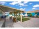 Inviting backyard featuring a covered patio, gravel, and a green turf area for outdoor activities at 1830 Ginger Blossom Ave, North Las Vegas, NV 89031