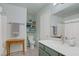 Bright bathroom featuring a marble countertop, light green cabinets, and neutral wall color at 1830 Ginger Blossom Ave, North Las Vegas, NV 89031