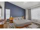 Bright bedroom featuring a bold accent wall, modern bed frame, and stylish geometric rug at 1830 Ginger Blossom Ave, North Las Vegas, NV 89031