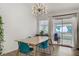 Contemporary dining space features a modern chandelier and seamless access to the outdoor patio at 1830 Ginger Blossom Ave, North Las Vegas, NV 89031
