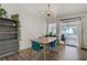 Bright dining area with modern lighting, stylish furnishings, and sliding glass doors to the patio at 1830 Ginger Blossom Ave, North Las Vegas, NV 89031