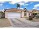 Well-kept single-story house featuring a two-car garage, desert landscaping, and a neatly manicured front yard at 1830 Ginger Blossom Ave, North Las Vegas, NV 89031