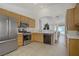 Spacious kitchen featuring stainless steel appliances and tile floors open to dining area at 1830 Ginger Blossom Ave, North Las Vegas, NV 89031