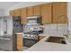 Updated kitchen with stainless steel appliances, wood cabinets, and a modern faucet at 1830 Ginger Blossom Ave, North Las Vegas, NV 89031