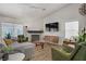 Bright living room features a decorative fireplace, contemporary furniture, and plenty of natural light at 1830 Ginger Blossom Ave, North Las Vegas, NV 89031