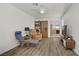 Bright living area with wood laminate floors, ceiling fan, and open archway to the kitchen at 1830 Ginger Blossom Ave, North Las Vegas, NV 89031