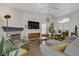 Bright living room featuring vaulted ceilings, modern furnishings, fireplace, and wood-look floors at 1830 Ginger Blossom Ave, North Las Vegas, NV 89031