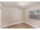 A cozy bedroom features wood-look floors and a window bringing in light at 2110 Sleepy Ct, Las Vegas, NV 89106