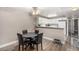 Cozy dining area with a modern table set, adjacent to a bright, white kitchen at 2110 Sleepy Ct, Las Vegas, NV 89106